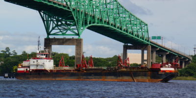 Manson Construction's Hopper Dredge Newport Sails Under a Bridge in Ft. Pierce, FL