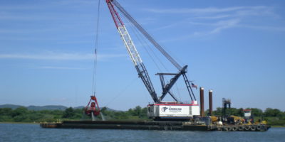 American Construction Company's Bucket Dredge Patriot Transferring Dredged Material to a Scow