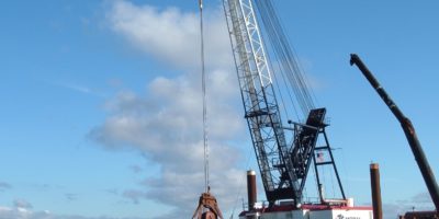 American Construction Company's Bucket Dredge Patriot Loads a Barge in Grays Harbor, WA
